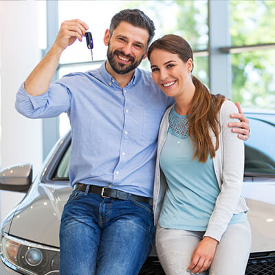 couple excited about their vehicle purchase
